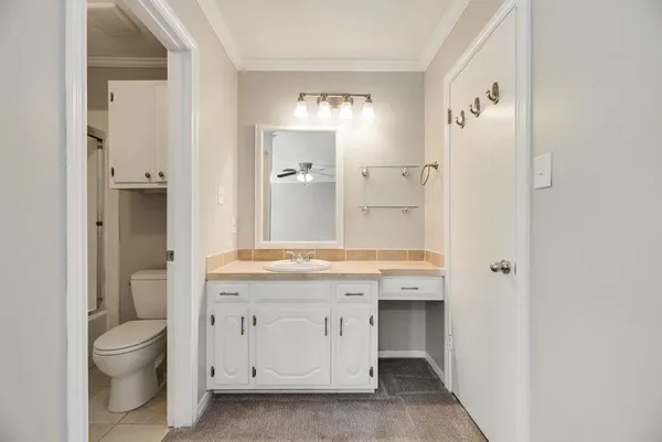 a bathroom with a double vanity sink toilet mirror and shower