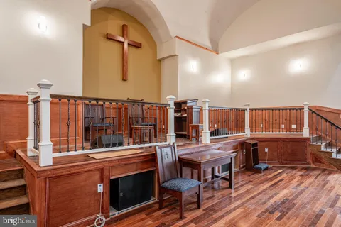 a living room with a table chairs and a kitchen view
