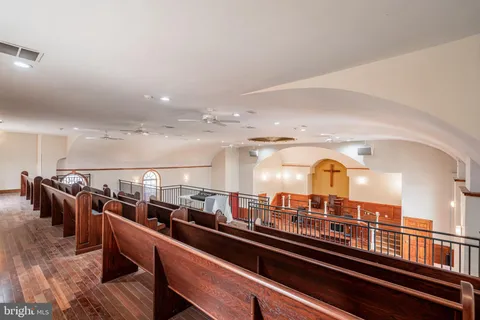 a living room with lots of furniture and a large window