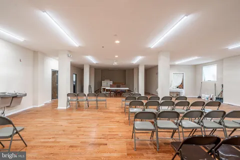 a room with lots of chairs and mirrors