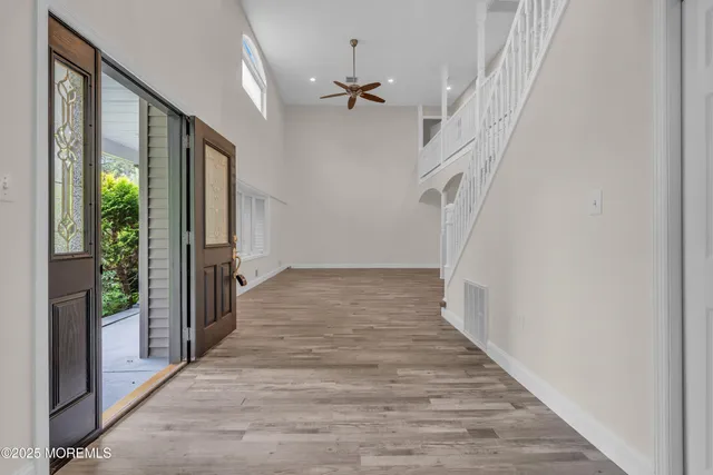 a view of a kitchen with furniture and wooden floor