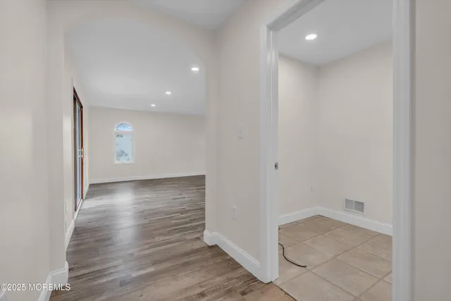a kitchen with granite countertop a sink a stove and a wooden floor
