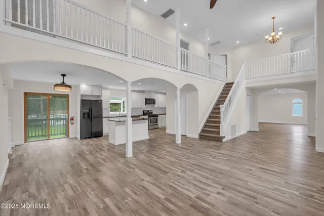 a kitchen with stainless steel appliances granite countertop a sink and a refrigerator