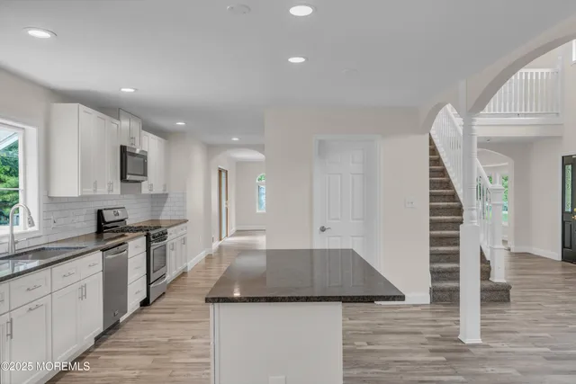 a bathroom with a sink a mirror and a shower