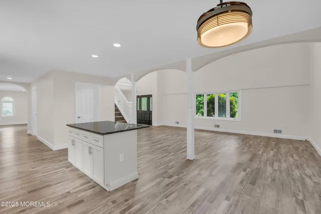 an empty room with a window and a ceiling fan