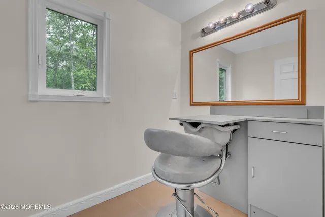 a view of a kitchen with furniture and an empty room