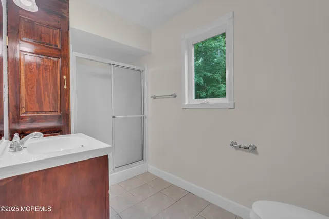 an empty room with windows and fan view