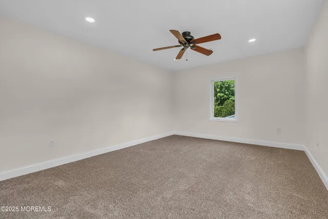 a white bath tub sitting in a bathroom next to a window