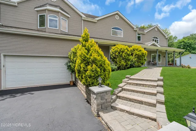a view of a hallway view with wooden floor and staircase
