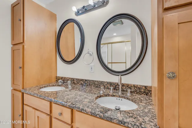 a view of a house with large windows and wooden fence
