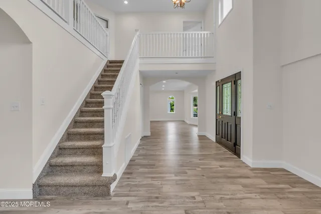 a view of a hallway with wooden floor and entryway