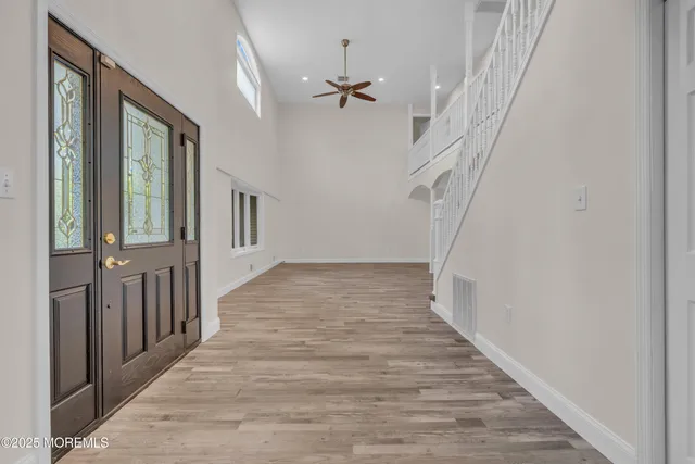 a kitchen with stainless steel appliances granite countertop a stove a sink and white cabinets