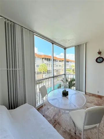 a dining room with furniture and a potted plant