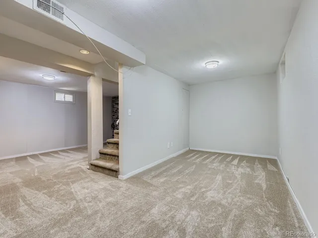 a dining room with furniture a rug and a fireplace
