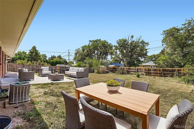 a view of backyard with swimming pool