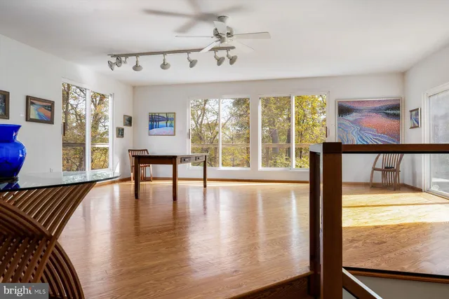 a bedroom with a bed window and flat screen tv