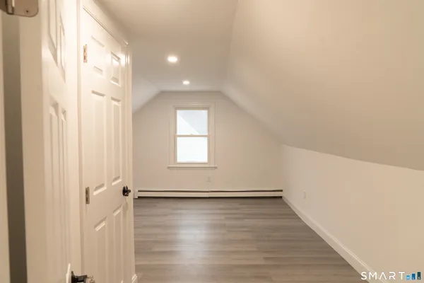 a view of a livingroom with wooden floor and window