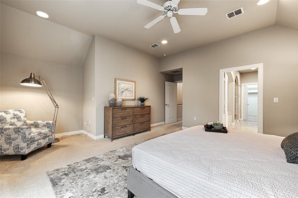 6269 Oram Street, Unit 10 Dallas, TX 75214 - Photo 19 of 25 a bedroom with a bed and a chandelier