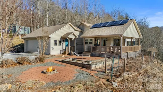 a view of a white house with wooden walls and floor to ceiling window