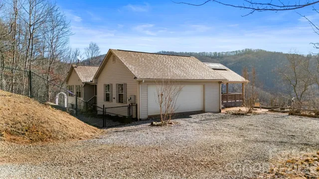 a view of a house with a yard covered in snow