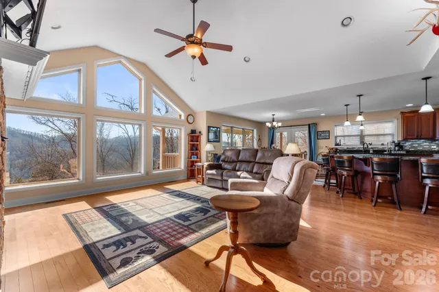 a living room with furniture and a floor to ceiling window
