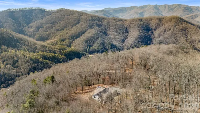 a view of a dry yard with mountains in the background