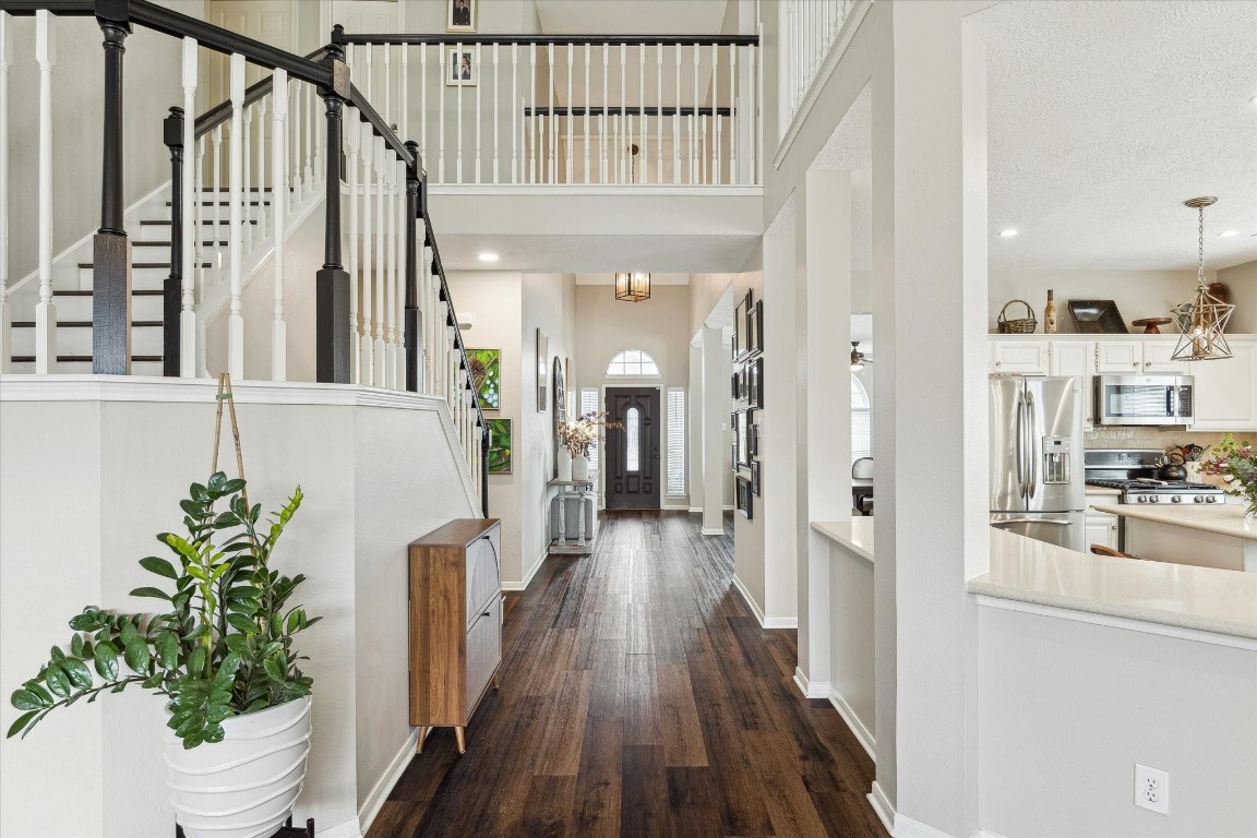 9831 Therrell Drive Houston, TX 77064 - Photo 19 of 44 a view of a hallway with wooden floor and staircase