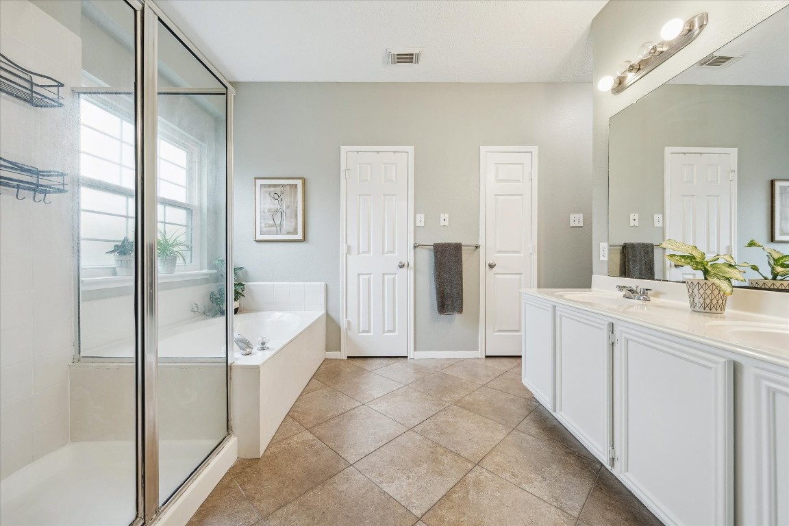 9831 Therrell Drive Houston, TX 77064 - Photo 27 of 44 a spacious bathroom with a shower a sink and a mirror