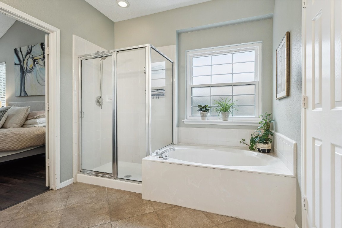 9831 Therrell Drive Houston, TX 77064 - Photo 28 of 44 a bathroom with a bathtub and a shower