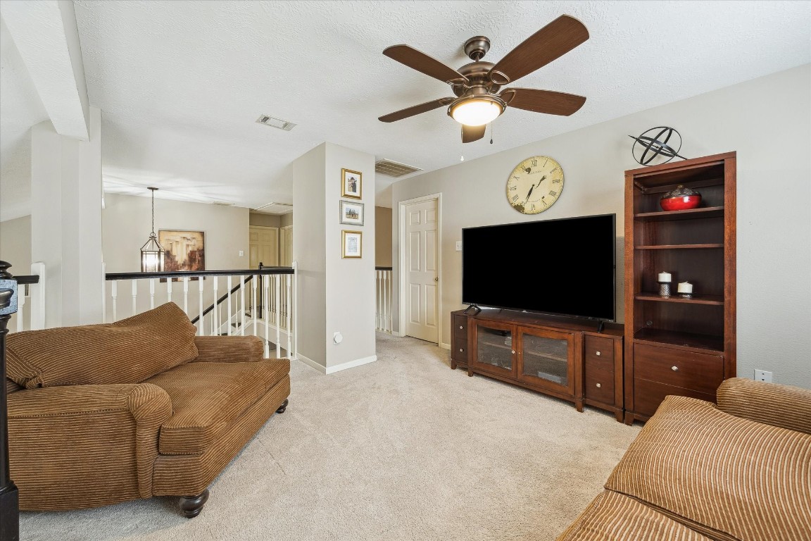 9831 Therrell Drive Houston, TX 77064 - Photo 31 of 44 a living room with furniture and a flat screen tv