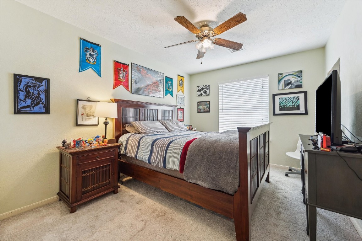 9831 Therrell Drive Houston, TX 77064 - Photo 33 of 44 a bedroom with a bed and a flat screen tv