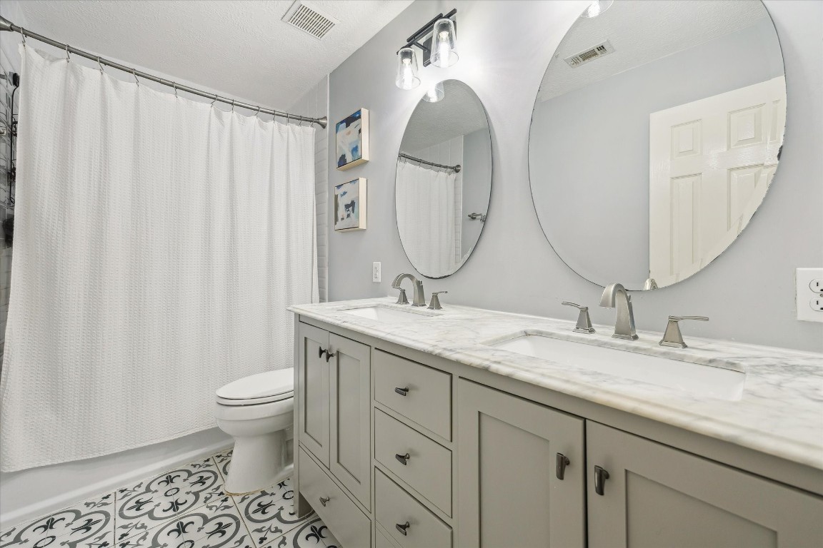 9831 Therrell Drive Houston, TX 77064 - Photo 34 of 44 a bathroom with a granite countertop sink and a mirror