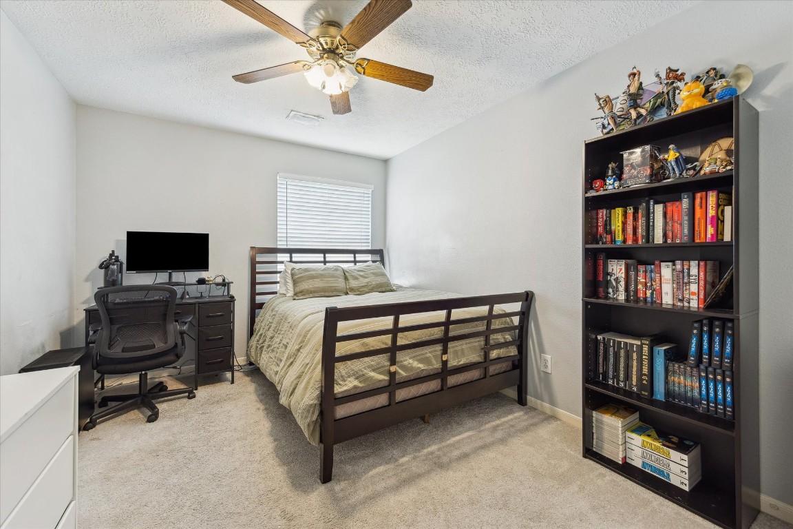 9831 Therrell Drive Houston, TX 77064 - Photo 35 of 44 a bedroom with furniture and a book shelf