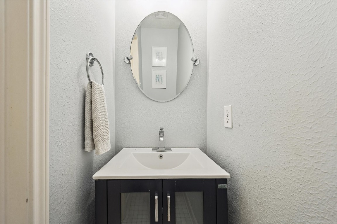 9831 Therrell Drive Houston, TX 77064 - Photo 37 of 44 a bathroom with a sink a mirror and a window