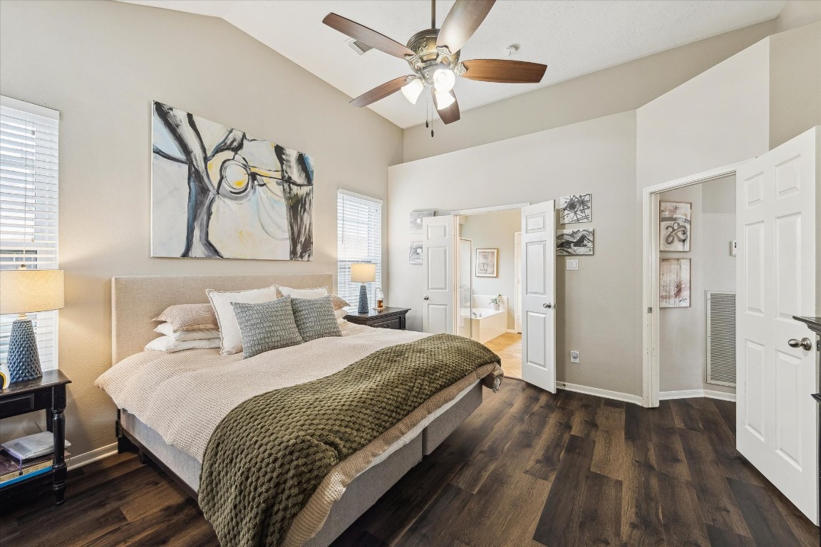 9831 Therrell Drive Houston, TX 77064 - Photo 4 of 44 a spacious bedroom with a bed and a chandelier