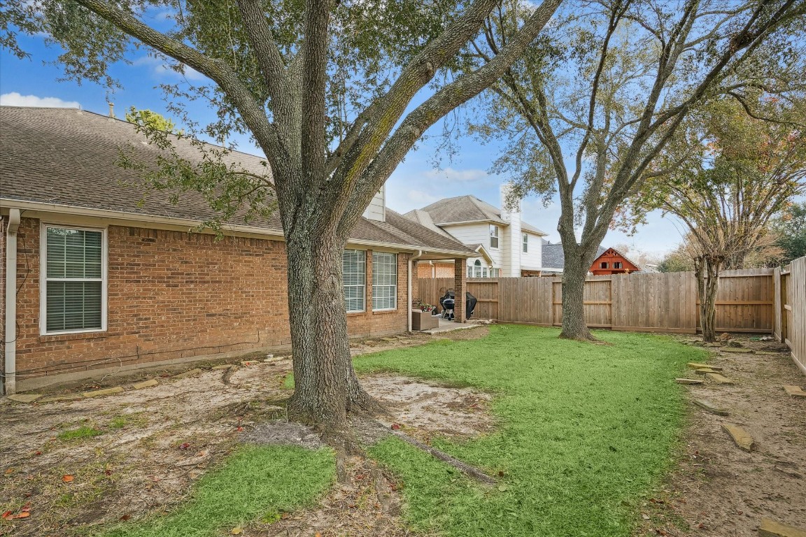 9831 Therrell Drive Houston, TX 77064 - Photo 41 of 44 a view of a yard in front of a house with large tree