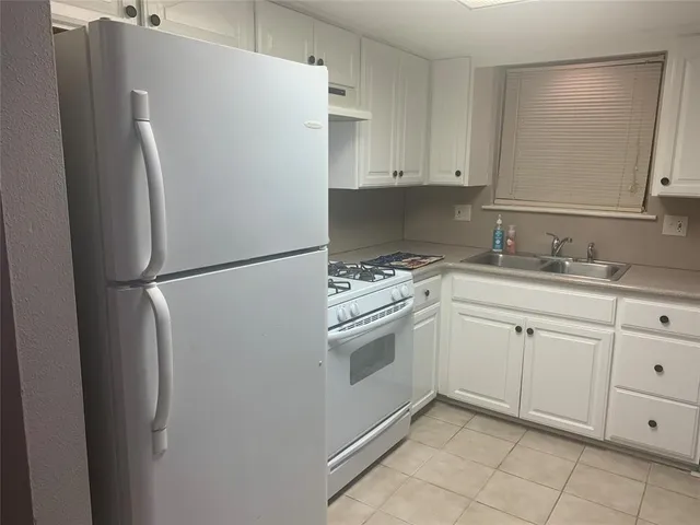 a white refrigerator freezer sitting in a kitchen
