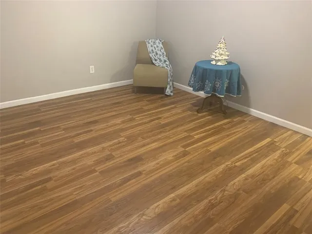 a view of a livingroom with wooden floor and a chandelier