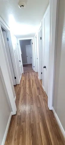 a view of a room with wooden floor and staircase