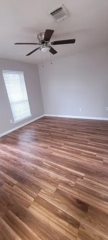 a view of a room with wooden floor