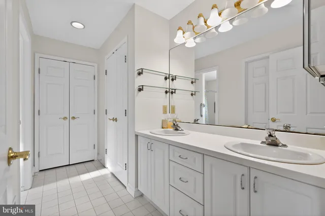 a bathroom with a sink double vanity and a mirror