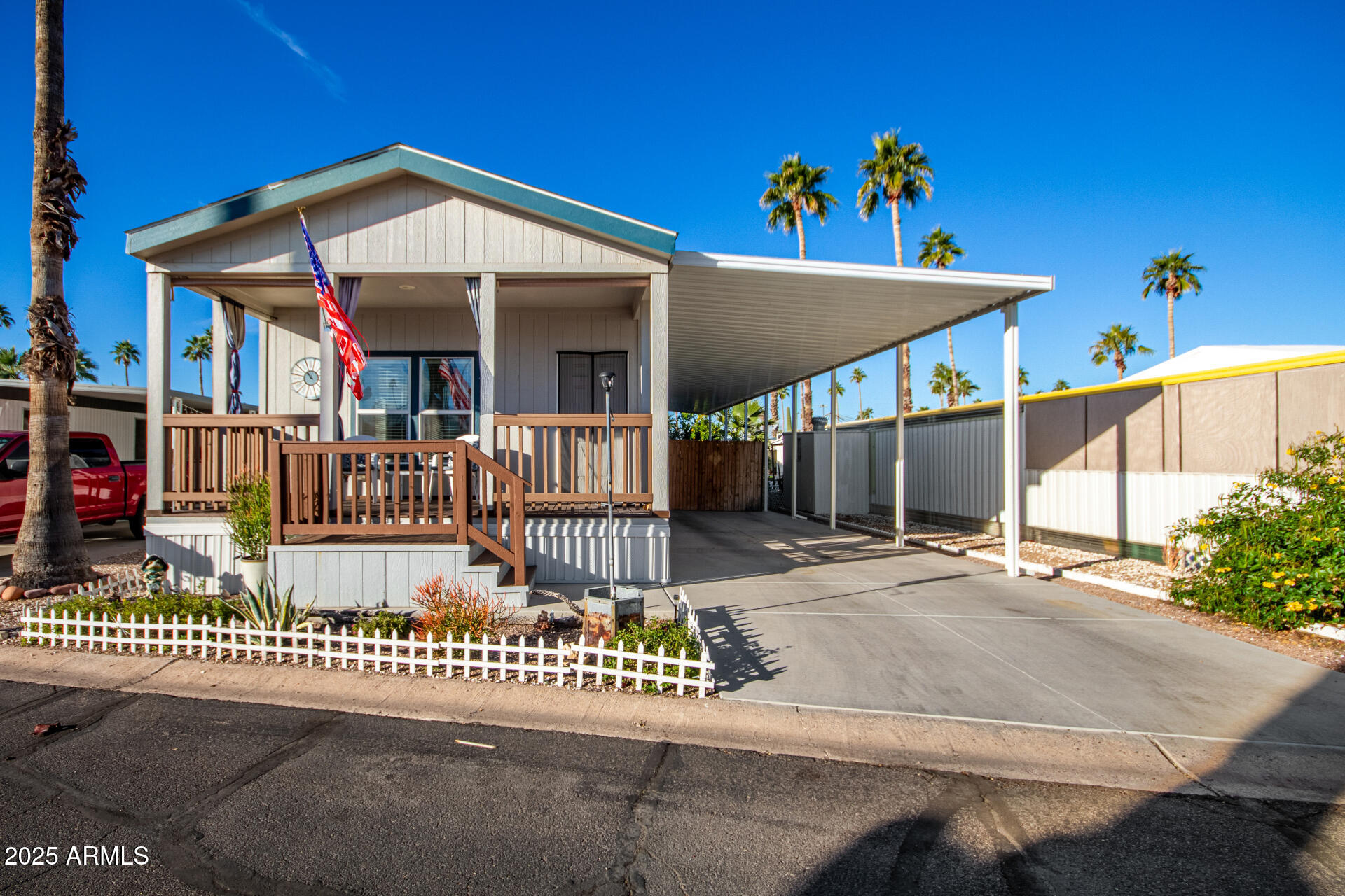 10540 East Apache Trail, Unit 93 Apache Junction, AZ 85120 - Photo 2 of 27 a view of a house with a small yard and deck