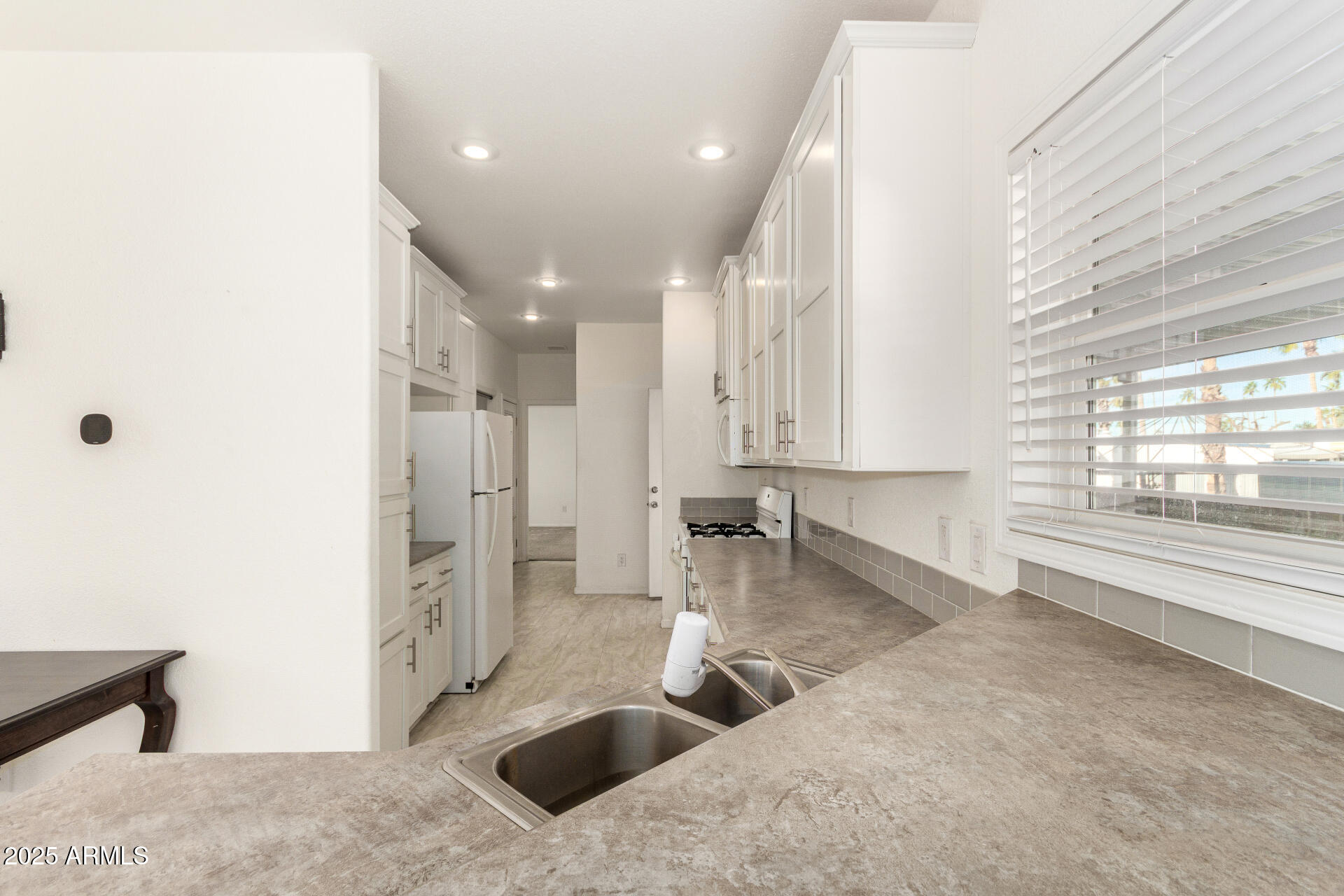 10540 East Apache Trail, Unit 93 Apache Junction, AZ 85120 - Photo 8 of 27 a kitchen with stainless steel appliances granite countertop a sink stove and refrigerator