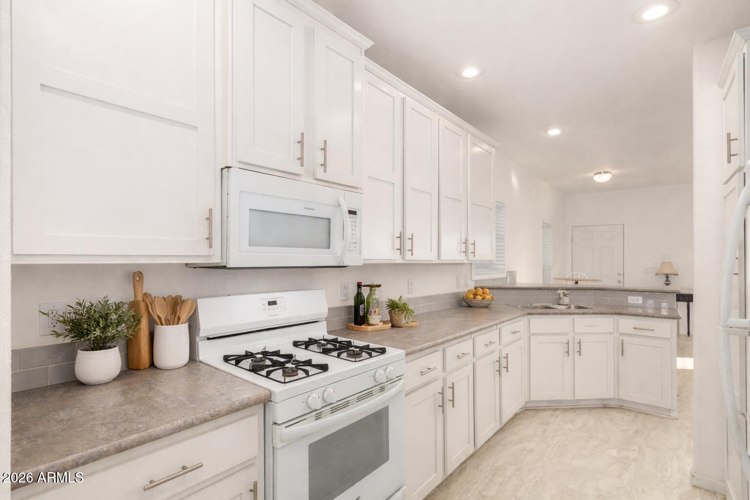 10540 East Apache Trail, Unit 93 Apache Junction, AZ 85120 - Photo 10 of 27 a kitchen with white cabinets and appliances