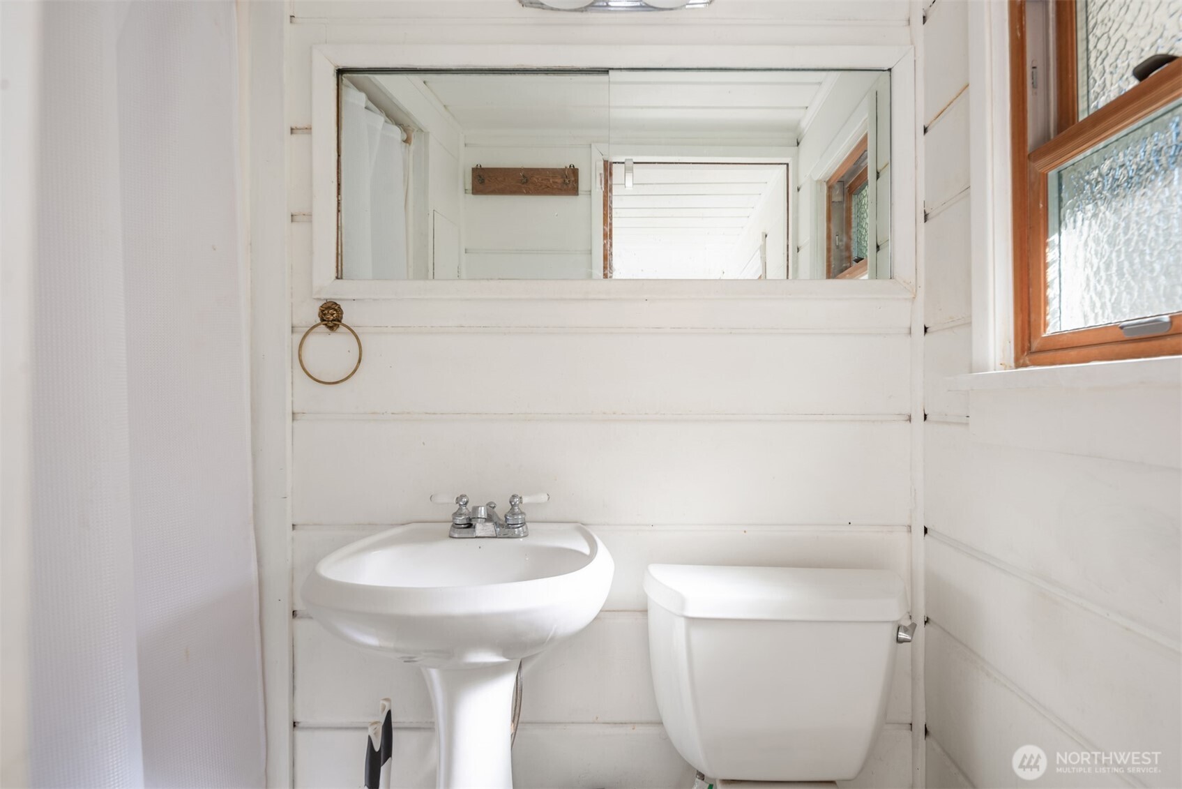 6422 49th Avenue Southwest Seattle, WA 98136 - Photo 14 of 20 a bathroom with a sink toilet and a mirror
