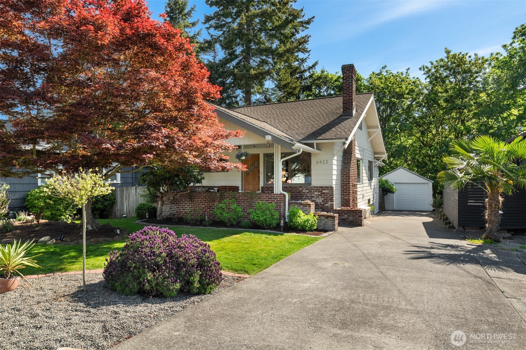 6422 49th Avenue Southwest Seattle, WA 98136 - Photo 2 of 20 a view of a white house next to a yard with big trees