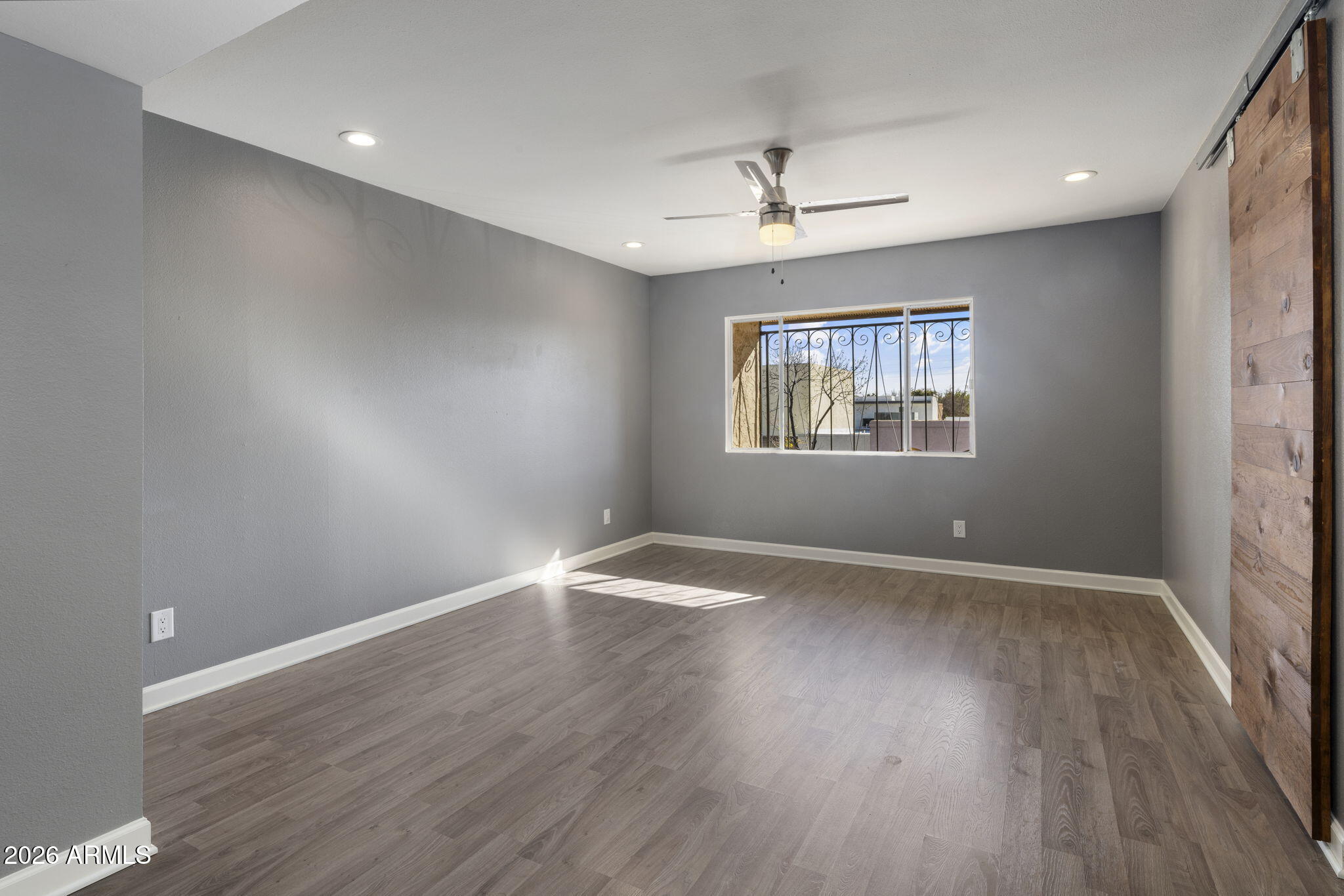 1842 West Marlette Avenue Phoenix, AZ 85015 - Photo 13 of 30 an empty room with wooden floor and windows