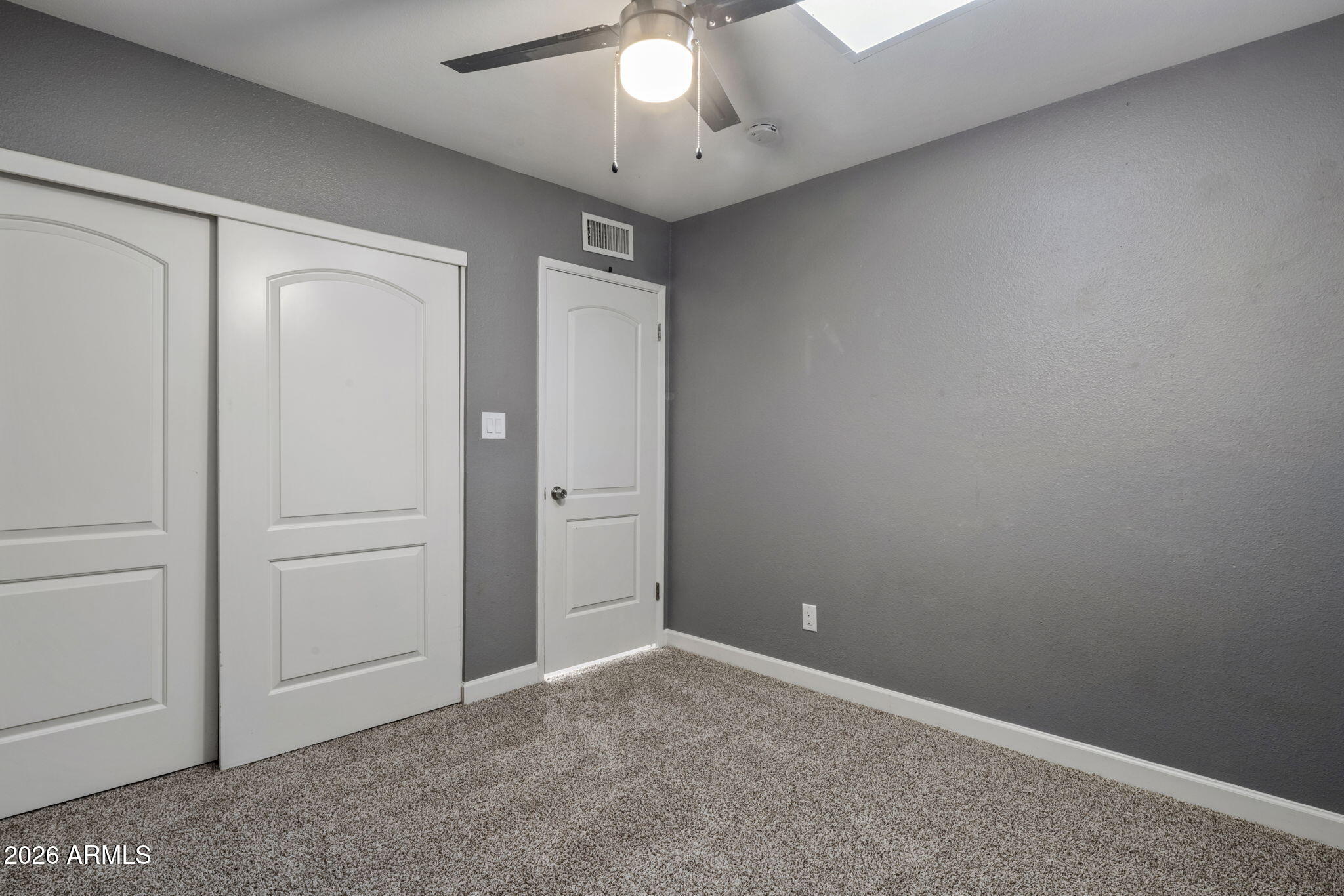 1842 West Marlette Avenue Phoenix, AZ 85015 - Photo 19 of 30 an empty room with a empty space and a ceiling fan