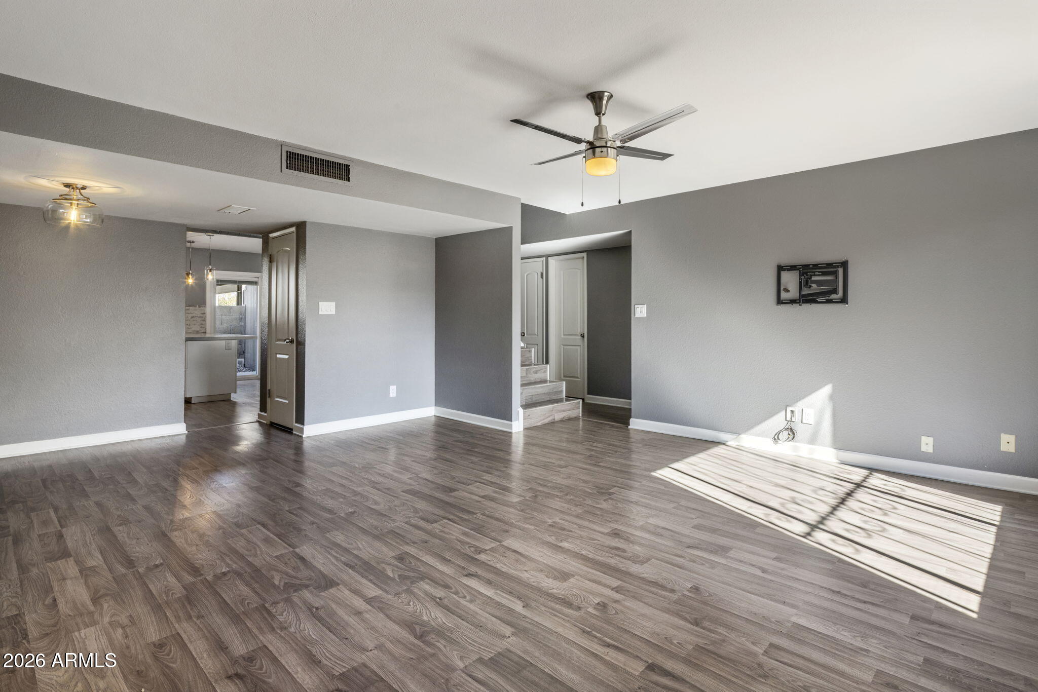 1842 West Marlette Avenue Phoenix, AZ 85015 - Photo 2 of 30 a view of a livingroom with a hardwood floor and a ceiling fan