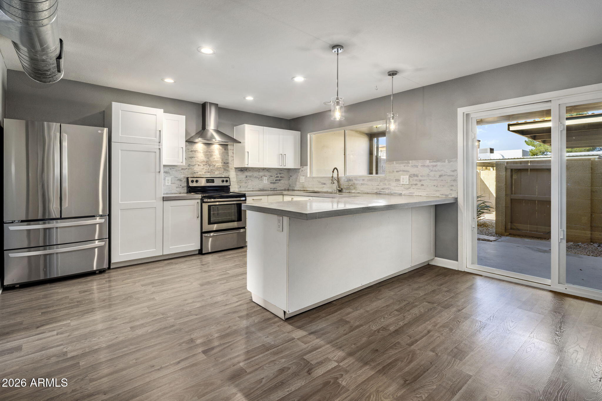 1842 West Marlette Avenue Phoenix, AZ 85015 - Photo 4 of 30 a kitchen with stainless steel appliances granite countertop a refrigerator a sink and a stove
